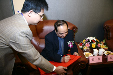 中國質(zhì)量檢驗協(xié)會會員工作部副主任張百熙(左一)在活動現(xiàn)場懇請全國政協(xié)副主席阿不來提·阿不都熱西提(右一)為“全國質(zhì)量知識競賽”決賽活動簽名留念